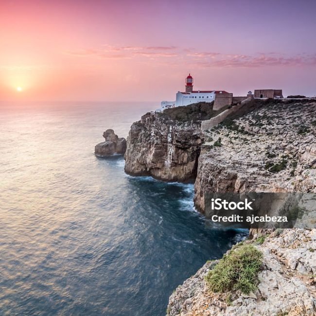 View of the lighthouse and cliffs at Cape St. Vincent at sunset.